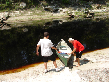 Lee and Alex launch the canoe into the Suwannee River