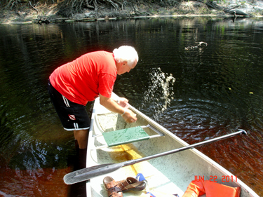 Lee had to hand shovel some of the water out of the canoe since the canoe did have a leak.