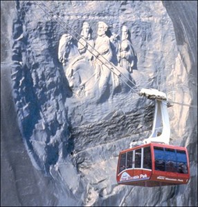 the cable car in front of the carving at Stone Mountain