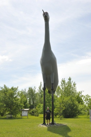 Lee Duquette stands by the World's Largest Sandhill Crane statue 