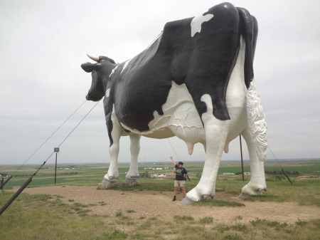Karen Duquette stands under the World's Largest Holstein cow statue
