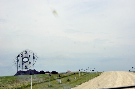 The dirt road leading up to this sculpture is lined with birds.10