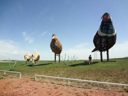 Karen Duquette by the four pheasants on the Enchanted Highway