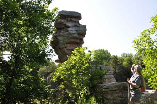 Karen Duquette looks up at the Balancing Rock 