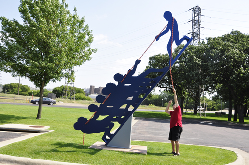 Lee Duquette plays tug-of-war with the sculpture