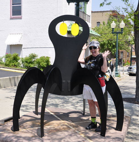 Karen Duquette with a scary spider sculpture