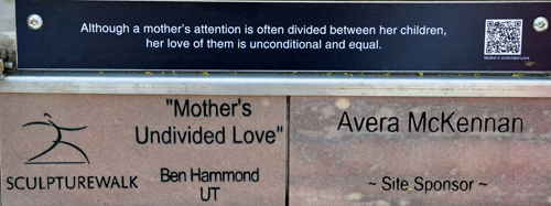 sign: Mother's Undivided Love sculpture