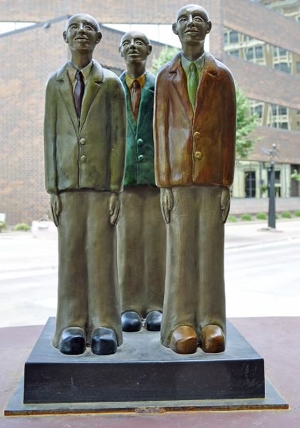 three men in suits sculpture