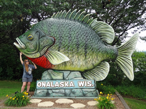 Karen Duquette with the Big Fish monument