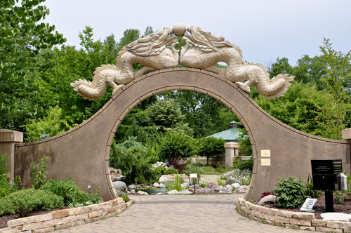 the moon gate is topped by two granite dragons