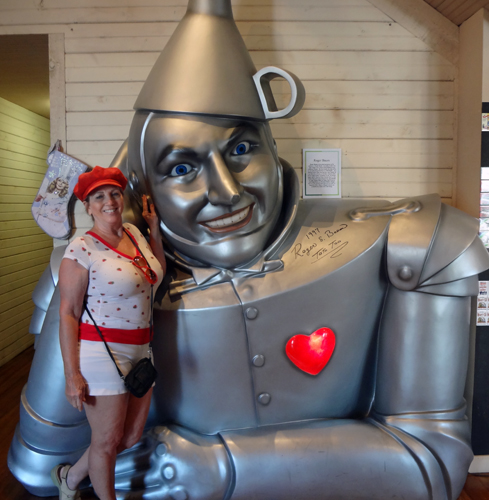 Karen Duquette stands beside a Giant Tin Man