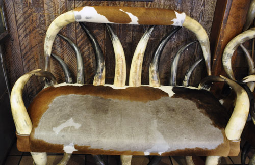 a cowhide covered bench