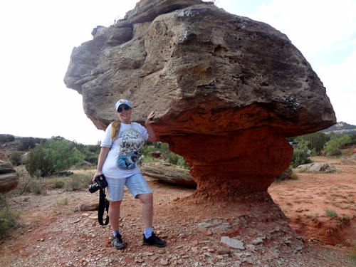 Karen Duquette at a fragile balanced rock deep on the floor of the Palo Duro Canyon