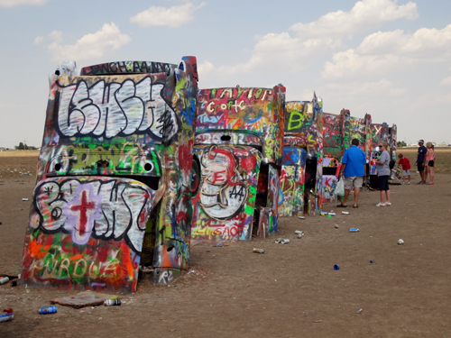 Brightly-painted Cadillacs, all in a row at Cadillac Ranch in Texas