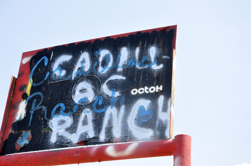 the sign over the gate at Cadillac Ranch