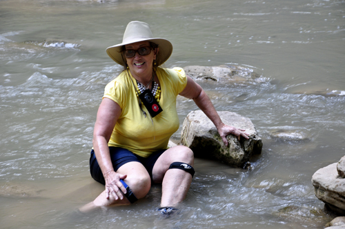 Karen Duquette sitting in the Virgin River at Zion National Park