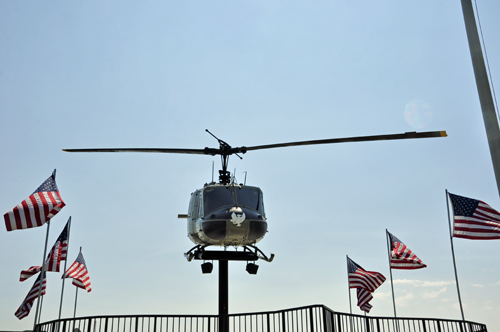 a UH-1H Huey helicopter and USA flags
