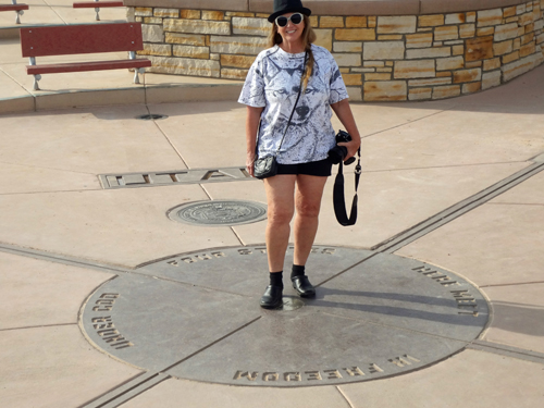 Karen Duquette stands in four states at one time