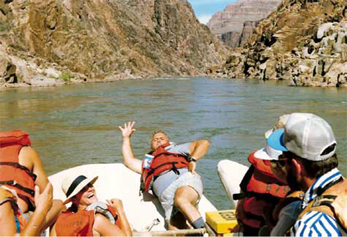 Lee Duquette on the bow of the raft in the Grand Canyon