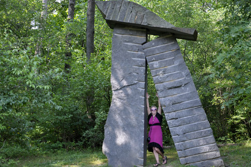 Karen Duquette under a giant art sculpture
