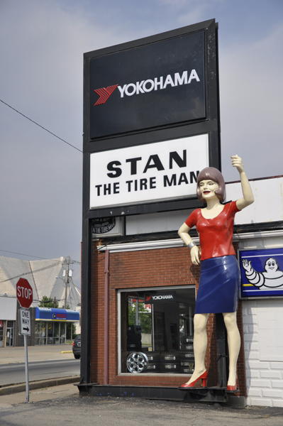 A giant female statue outside the store that says Stan The Tire Man