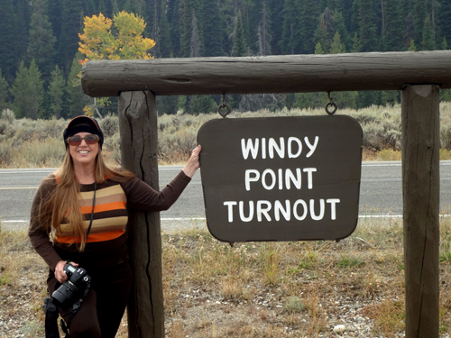 Karen Duquette at the Windy Point Turnout sign
