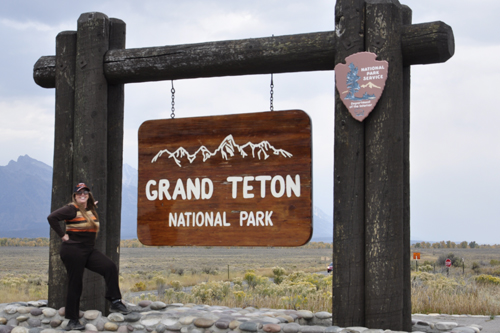 Karen Duquette at the Grand Teton National park sign