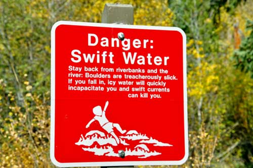 warning sign to stay out of the waterfall