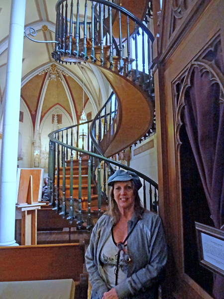 Karen Duquette by the miraculous spiral staircase at Loretta Chapel