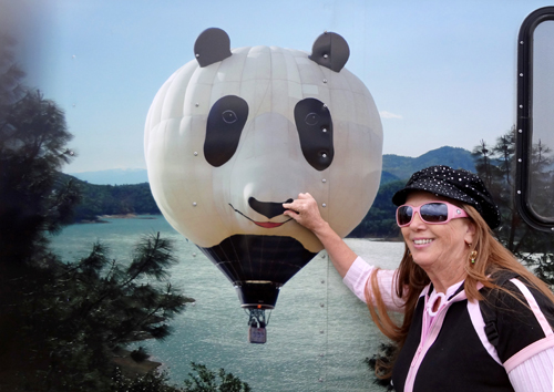 Karen Duquette pinches the nose of the panda balloon'