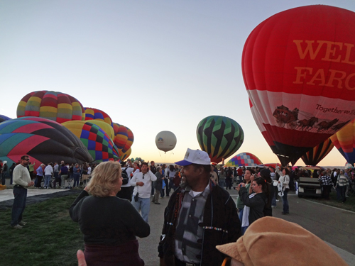 hot air balloons and lots of people