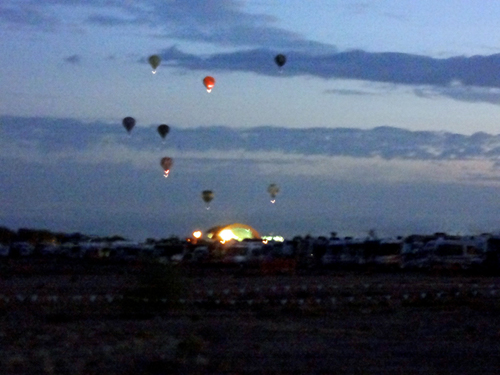 a few hot air balloons in early morning flight