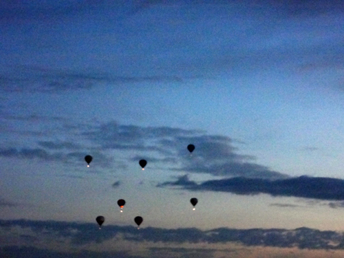 a few hot air balloons in early morning flight