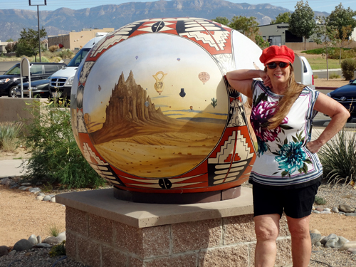 Karen Duquette and a globe outside the musuem