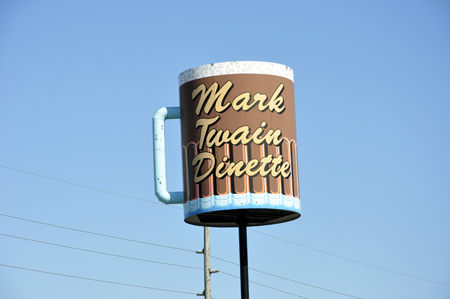 A rotating coffe cup above a diner.