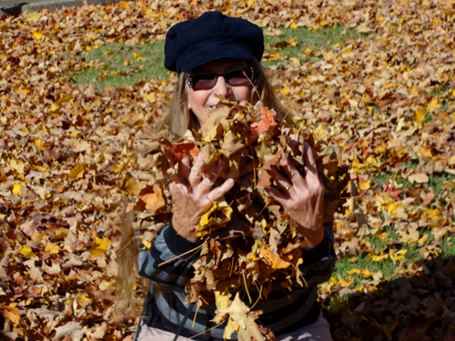 Karen Duquette playing in the leaves
