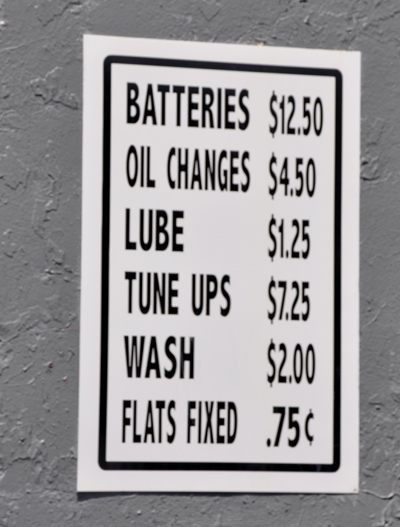 old prices on a sign near the gas pump