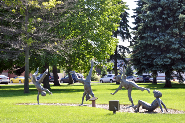 statues of the kids playing in the park 