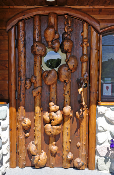a carved door of burls at Legs Inn in Cross Village
