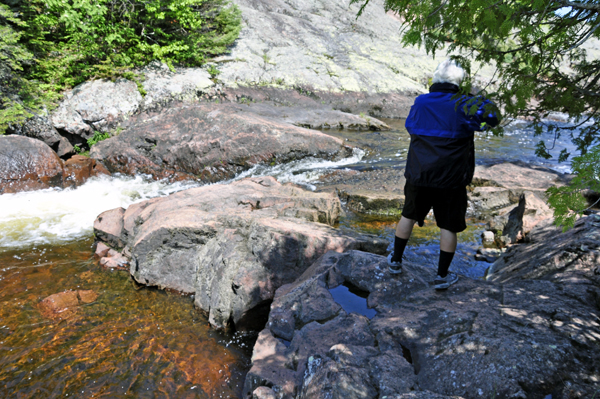 Lee Duquette taking a photo of Rainbow Falls