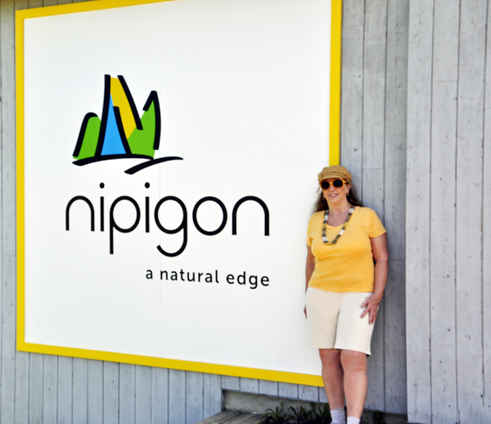 Karen Duquette at the Nipigon sign