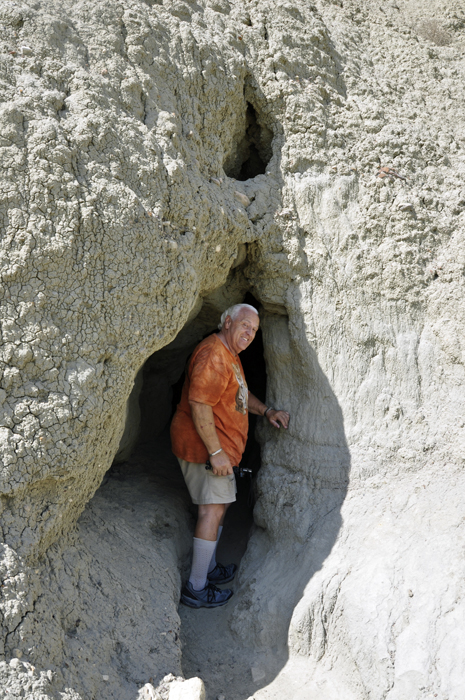 Lee Duquette peeks into the cave at Castle Butte