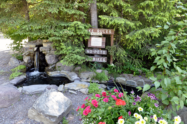 Mini waterfaull and fishing sign at Mountain Meadow RV Park