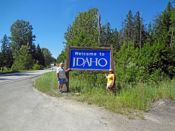 the two RV Gypsies by the Welcome to Idaho sign
