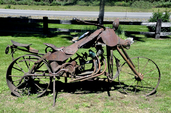 metal sculpture of am old motor bike