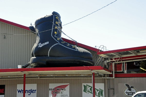 A big boot on top of a shoe store