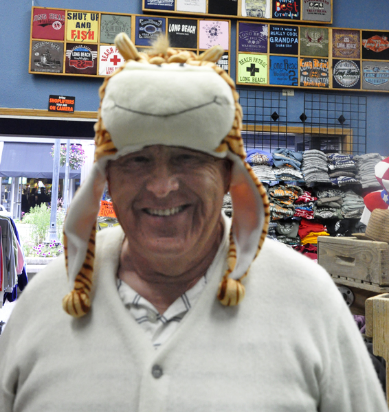 Lee Duquette trying on some hats in the store