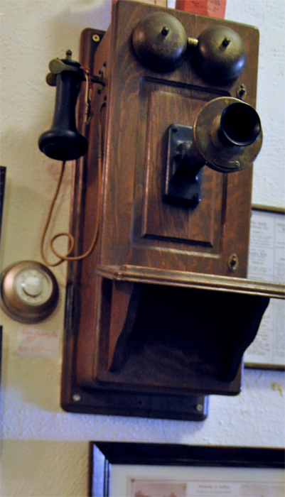 an old telephone on the wall in The Occidental Hotel