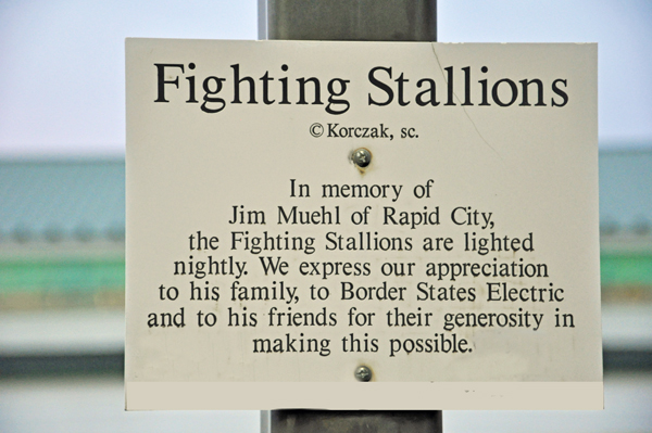 sign for the Fighting Stallions statue