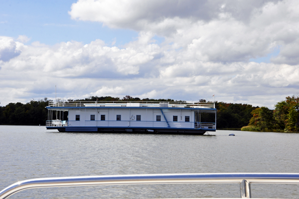 A LARGE HOUSEBOAT ON THE MAGOTHY RIVER